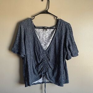 Women’s Express navy blue polka dot cropped, cinch top.